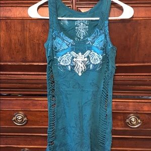 Tunic tank shredded on sides.